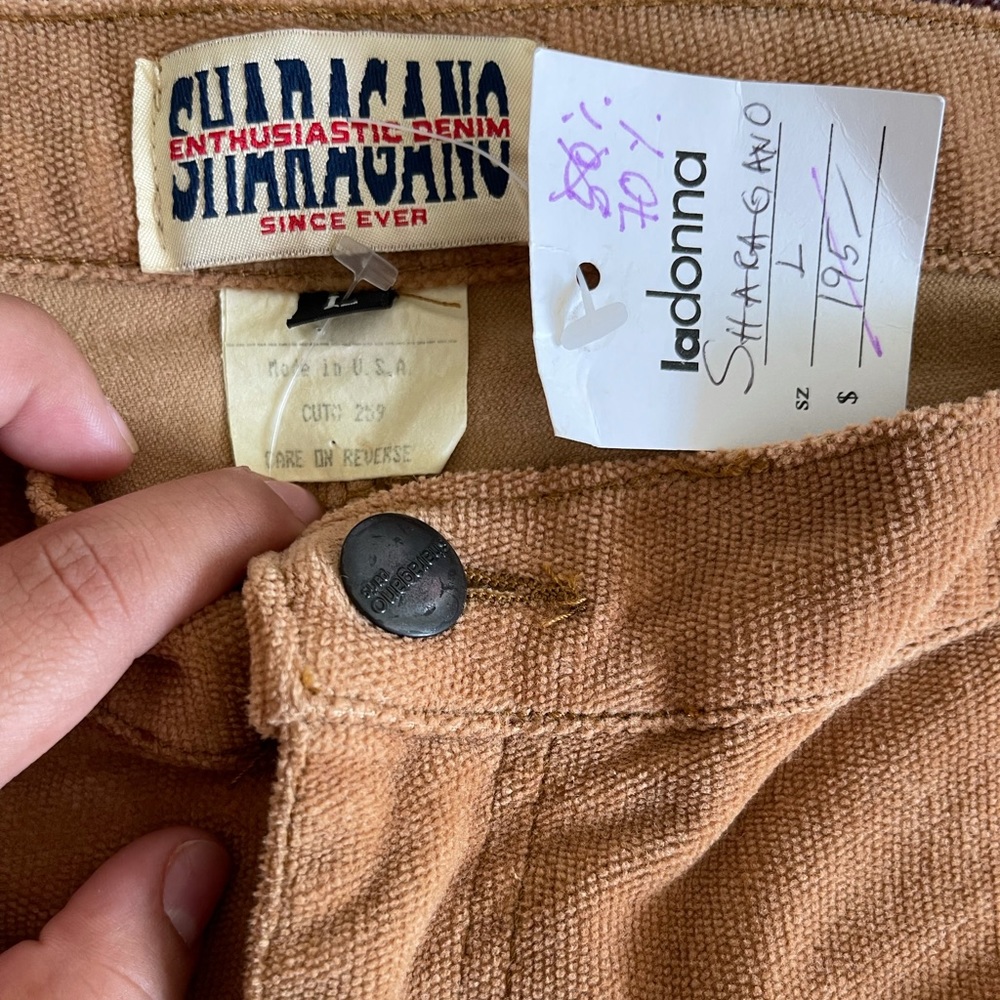 Brown corduroy flare pants with embroidered detailing at the bottom size L